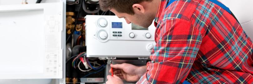 Ein Handwerker optimiert eine Heizungsanlage.