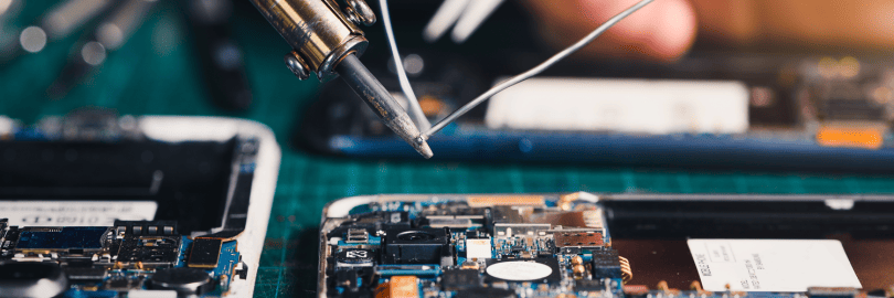 Ein Smartphone liegt geöffnet auf einem Tisch und wird repariert 